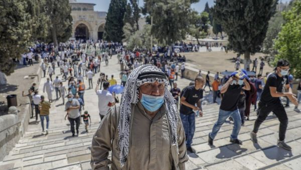 Palestinian Muslims leave after performing the Friday prayer outside the Dome of the Rock Mosque, in Jerusalem's Al-Aqsa mosques compound, amid the novel coronavirus pandemic crisis, on August 21, 2020. AHMAD GHARABLI / AFP