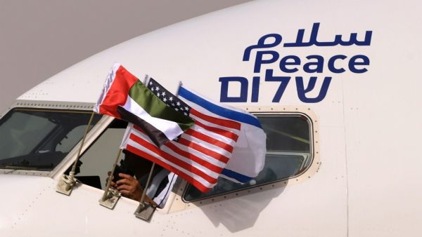 The Emirati, Israeli and US flags are picture attached to an air-plane of Israel's El Al, adorned with the word "peace" in Arabic, English and Hebrew, upon it's arrival at the Abu Dhabi airport in the first-ever commercial flight from Israel to the UAE, on August 31, 2020. A US-Israeli delegation including White House advisor Jared Kushner took off on a historic first direct commercial flight from Tel Aviv to Abu Dhabi to mark the normalisation of ties between the Jewish state and the UAE. KARIM SAHIB / AFP