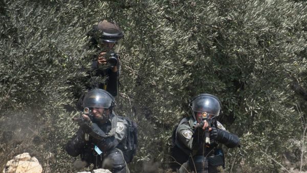 A member of the Israeli security forces fires a rubber bullet towards Palestinian protesters during clashes with Israeli security forces following a demonstration to protest Israel's plan to annex parts of the occupied West Bank, in the village of Kfar Qaddum, on September 4 2020. JAAFAR ASHTIYEH / AFP