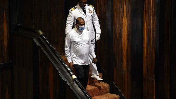 Sri Lanka's convicted murderer Premalal Jayasekara (L) arrives for a sworn in as a member of parliament from the ruling party in Colombo on September 8, 2020. Jayasekara becomes the first convict facing a death sentence to become a legislator in Sri Lanka. ISHARA S. KODIKARA / AFP