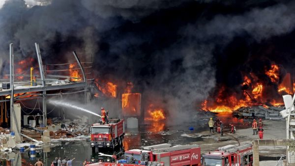 Lebanese firefighters try to put out a fire that broke out at Beirut's port area, on September 10, 2020. Thick black columns of smoke rose into the sky, as the army said it had engulfed a warehouse storing engine oil and vehicle tyres.  ANWAR AMRO / AFP