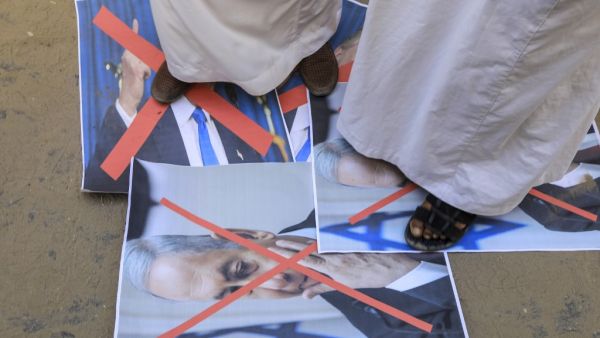Palestinian men step on the portrait of the Israeli Premier during a protest in Deir al-Balah, in central Gaza Strip, on September 12, 2020, to condemn the normalisation of ties between Israeli and Bahrain. The Palestinian cause has long cemented ties between Middle East nations with divergent interests, but amid shifting regional alliances they are increasingly isolated and in need of new friends, analysts say. In the latest blow, Bahrain broke ranks and agreed on Friday to open diplomatic ties with Israel