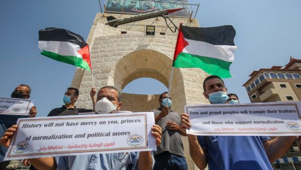 Palestinians carry placards during a protest in Rafah in the southern Gaza Strip, on September 12, 2020, to condemn the normalisation of ties between Israeli and Bahrain. The Palestinian cause has long cemented ties between Middle East nations with divergent interests, but amid shifting regional alliances they are increasingly isolated and in need of new friends, analysts say. In the latest blow, Bahrain broke ranks and agreed on Friday to open diplomatic ties with Israel, in a deal announced in Washington 