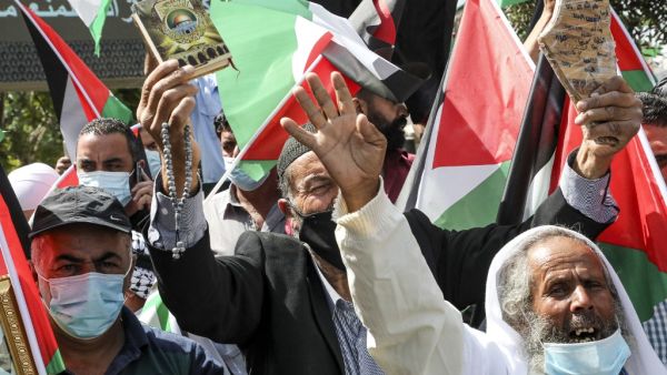 Demonstrators, mask-clad due to the COVID-19 coronavirus pandemic, demonstrate with Palestinian flags during a protest against the United Arab Emirates' and Bahrain's decisions to normalise relations with Israel, in the centre of the flashpoint city of Hebron in the occupied West Bank on September 15, 2020. Palestinian leaders had earlier called for demonstrations against the "shameful" deals the United Arab Emirates and Bahrain are set to sign with Israel. Officials from both Gulf states are due to attend 