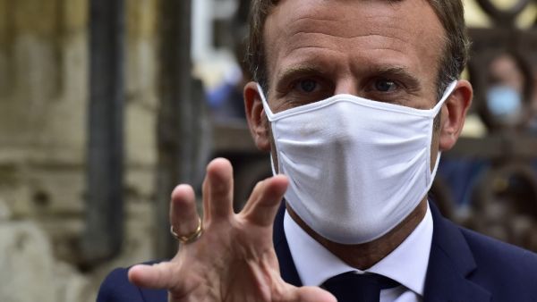 French President Emmanuel Macron, wearing a protective face mask, speaks to the journalists during a visit at the Polignac castle on September 18, 2020 in Condom, on the eve of the European Heritage Days and the third edition of the "Loto du Patrimoine" lottery draw aiming at help restoring heritage sites at risk. GEORGES GOBET / AFP / POOL