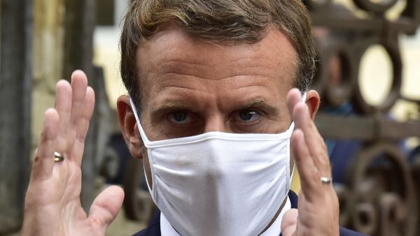 French President Emmanuel Macron, wearing a protective face mask, speaks to the journalists during a visit at the Polignac castle on September 18, 2020 in Condom, on the eve of the European Heritage Days and the third edition of the "Loto du Patrimoine" lottery draw aiming at help restoring heritage sites at risk. GEORGES GOBET / AFP / POOL