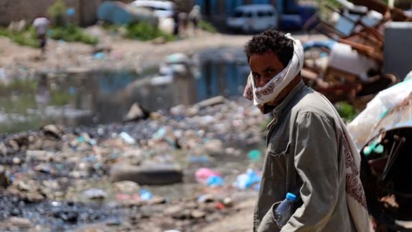 A manstands along a street flooded with open sewers and covered with rubbish in Yemen's third city of Taez, on September 19, 2020. Human Rights Watch warned of "deadly consequences" as a result of the obstruction of aid in war-torn Yemen, where the humanitarian effort has already been badly hit by the coronavirus crisis. Interviews with 35 humanitarian workers, 10 donor officials and 10 Yemeni health workers revealed a complex web of restrictions that hinder the flow of aid. AHMAD AL-BASHA / AFP
