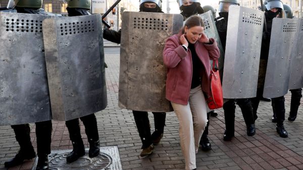 A woman hustles with law enforcement officers as they block the road during a demonstration called by opposition movement for an end to the regime of authoritarian leader in Minsk on September 20, 2020. Belarus President Alexander Lukashenko, who has ruled the ex-Soviet state for 26 years, claimed to have defeated opposition leader Svetlana Tikhanovskaya with 80 percent of the vote in the August 9, elections. AFP