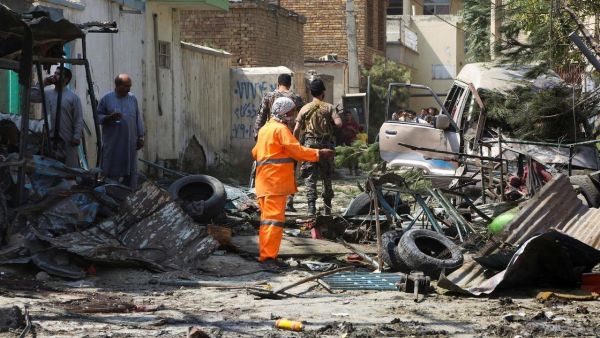 Afghan security personnel inspect the site of an explosion targeting Amrullah Saleh's convoy. (AFP)