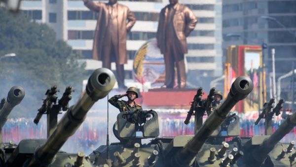In a file photo taken on September 9, 2018 Korean People's Army (KPA) soldiers salute as they ride tanks during a military parade and mass rally on Kim Il Sung square in Pyongyang. All eyes will be on North Korea October 10, 2020 as it celebrates the 75th birthday of the ruling Workers' Party, with speculation mounting for a "big event" showcasing the nuclear-armed nation's military strength.  Ed JONES / AFP
