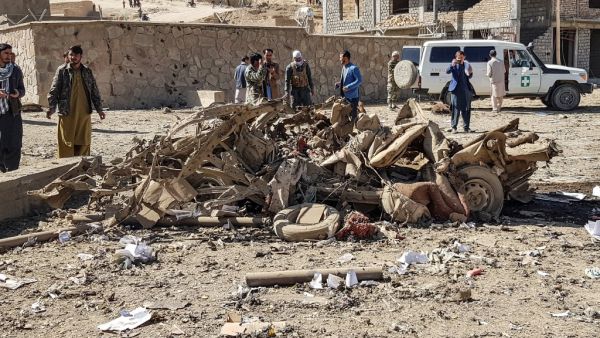 Security personnel and residents gather around the site of a car bomb attack that targeted an Afghan police headquarters in Feroz Koh, the capital of Ghor Province on October 18, 2020. A car bomb on October 18 targeting an Afghan police headquarters in the western province of Ghor killed at least 12 civilians and wounded more than 100, officials said. AFP