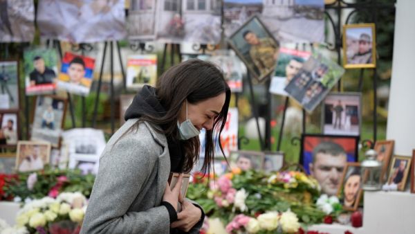 A woman cries at a makeshift memorial for Armenians killed during the military conflict with Azerbaijan over the breakaway region of Nagorno-Karabakh, outside the Armenian embassy in Moscow on October 20, 2020. Natalia KOLESNIKOVA / AFP