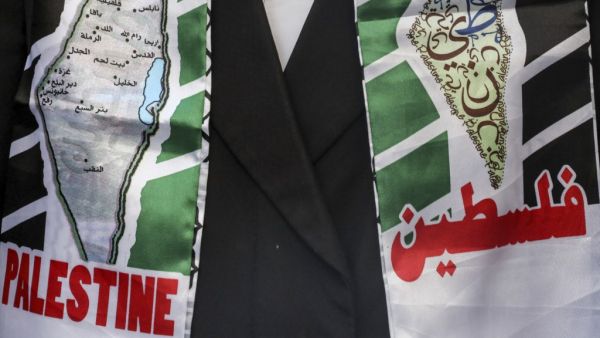 A member of the Neturei Karta movement, a small faction of anti-Zionist ultra-Orthodox Jews who oppose Israel's existence, wearing a scarf showing a map of historic Palestine with its Arabic city names and text in English and Arabic reading "Palestine", attends a demonstration in support of Palestinians held in Israeli prisons and hunger-striking detainee Maher al-Akhras in the centre of the flashpoint West Bank city of Hebron on October 21, 2020. The Palestinian on hunger strike for over 80 days since his 