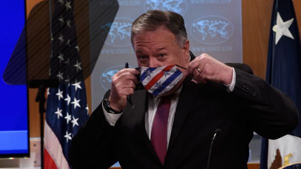 US Secretary of State Mike Pompeo puts on a facemask after a press conference at the State Department in Washington, DC, on October 21, 2020. US Secretary of State Mike Pompeo said Wednesday he hoped Sudan will soon recognize Israel as Washington moved to remove the Arab country as a state sponsor of terrorism."We continue to work to make the case to every country to recognize Israel," Pompeo told reporters.  NICHOLAS KAMM / POOL / AFP