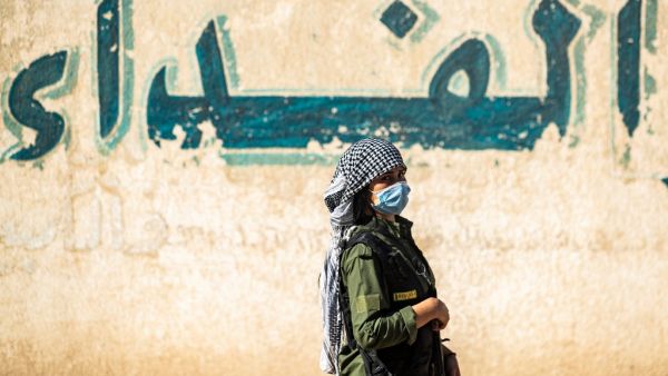 A Syrian Kurdish fighter stands guard during a rally in support of the Syrian Democratic Forces (SDF) and the People's Protection Forces and to denounce the recent attacks by Turkish forces on northeastern Syria, in the northeastern Syrian city of Qamishli, on October 24, 2020. Delil SOULEIMAN / AFP