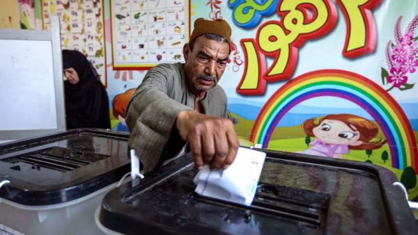 A man casts his ballot at a polling station in El-Ayyat, south of the Egyptian capital on October 24, 2020, during the first stage of the lower house elections. Polling stations opened in Egypt for parliamentary elections in which there was little doubt of a sweeping victory for supporters of hardline President Abdel Fattah al-Sisi. Some 63 million voters out of Egypt's more than 100 million people are eligible to elect 568 of the 596 lawmakers in the lower house, widely seen as a rubber-stamp body for exec