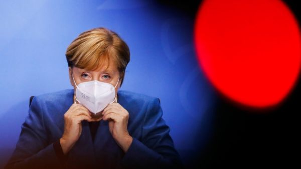German Chancellor Angela Merkel wears a face mask as she leaves after a news conference on new coronavirus restrictions following consultations with the premiers of Germany's 16 federal states at Chancellery in Berlin on October 28, 2020. FABRIZIO BENSCH / POOL / AFP