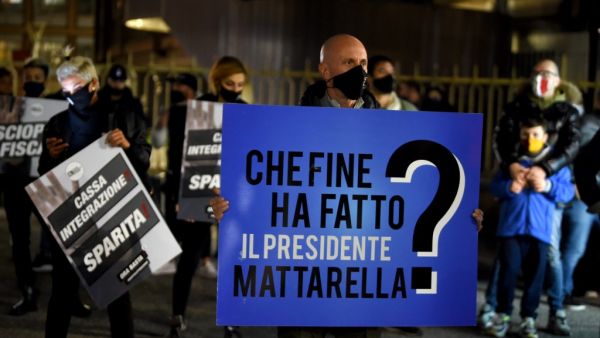 A protestor holds a banner reading "Where is president Mattarella" as owners of pubs, bars, restaurant and the activities affected by the measures to contain the Coronavirus COVID-19 as they protest in front of the Regione Lazio headquarters in Rome on October 28, 2020. Filippo MONTEFORTE / AFP