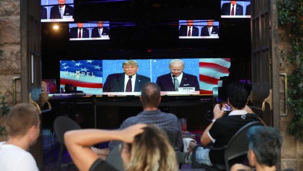 People sit and watch a broadcast of the first debate between President Donald Trump and Democratic presidential nominee Joe Biden at The Abbey, with socially distanced outdoor seating, on September 29, 2020 in West Hollywood, California. The debate being held in Cleveland, Ohio is the first of three scheduled debates between Trump and Biden. Mario Tama/Getty Images/AFP MARIO TAMA / GETTY IMAGES NORTH AMERICA / Getty Images via AFP