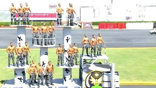 Rows of men with rows of muscles: New police cadets in Egypt put on a show of strength in a topless parade at a graduation ceremony outside Cairo on Thursday. (YouTube)