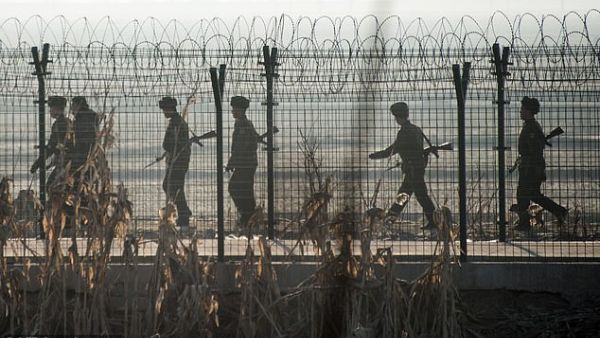 North Korean troops by a border fence with China. (AFP)