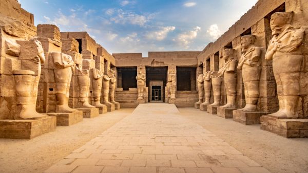 Large sculptures of pharaohs inside beautiful Egyptian landmark with hieroglyphics, and ancient symbols.  (Shutterstock/ File Photo)