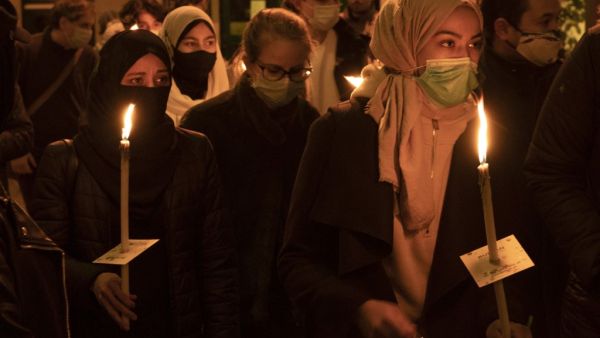 People attend a candlelight vigil remembering the victims of the terrorist attack in Vienna, Austria on November 5, 2020. Austria is mourning four civilians shot dead by a 20-year-old Islamic State sympathiser who attacked a popular nightlife area in the heart of Vienna on November 2, 2020, on the last night before a second coronavirus shutdown.  JOE KLAMAR / AFP