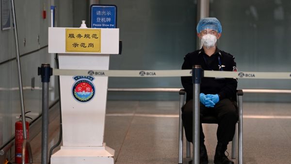 A security guard watches over the empty international arrivals channel at Beijing airport on November 6, 2020, after China banned foreign arrivals from France and a host of other countries, the latest in a growing number of entry bans as China closes itself off from a world still battling the coronavirus pandemic. GREG BAKER / AFP A security guard watches over the empty international arrivals channel at Beijing airport on November 6, 2020, after China banned foreign arrivals from France and a host of other countries, the latest in a growing number of entry bans as China closes itself off from a world still battling the coronavirus pandemic. GREG BAKER / AFP