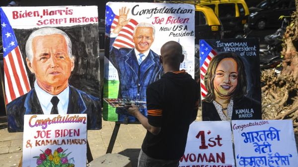A painter gives the final touches to a painting depicting newly elected US President Joe Biden, in Mumbai on November 8, 2020. INDRANIL MUKHERJEE / AFP
