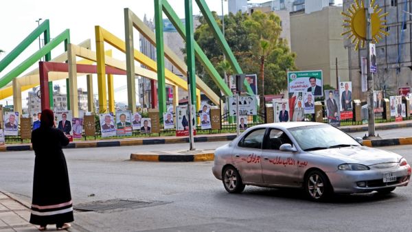 Vehicles drive past electoral banners for candidates and lists running in the 2020 general election in Jordan's northern Irbid on the day of the vote November 10, 2020. AFP