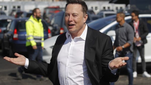 This file photo taken on September 3, 2020 shows Tesla CEO Elon Musk gesturing as he arrives to visit the construction site of the future US electric car giant Tesla, in Gruenheide near Berlin. The boom in demand for placing small satellites into orbit has boosted interest in small rockets, but industry players do not think the niche will become a business segment of its own. Odd ANDERSEN / AFP