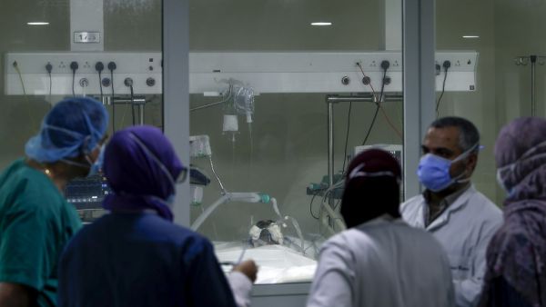 A medical team gathers in front of a COVID-19 patient's room in the intensive care unit of the Rafic Hariri University Hospital in the Lebanese capital Beirut, on November 13, 2020. JOSEPH EID / AFP
