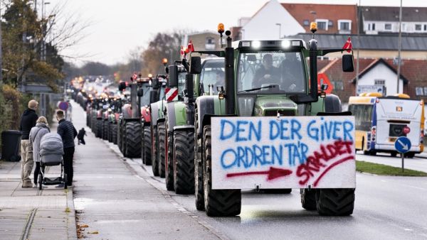 A farmer on a tractor with a placard reading 'The one who gives the order - Garbage' protests on November 14, 2020 in Aalborg, northwestern Denmark, during a rally against the Danish governments' unconstitutional order to cull all Mink in the country due to a mutated Covid-19 virus and against the following restrictions in seven municipalities in North Jutland. Denmark announced special restrictions for more than 280,000 people in the country's northwest after a mutated version of the new coronavirus linked