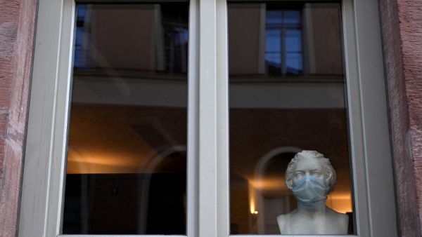 A bust of the former composer Ludwig van Beethoven is decorated with a protective mask in a store window in Weimar, Germany, on November 14, 2020, amid the ongoing novel coronavirus Covid-19 pandemic. Christof STACHE / AFP