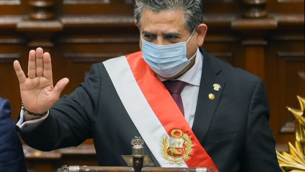 In this file picture taken on November 10, 2020 the head of the Peruvian Congress, Manuel Merino (R), waves after being sworn in as interim president in Lima, a day after the Congress voted to impeach and oust President Martin Vizcarra over corruption allegations. Peru's President Manuel Merino resigned on November 15, 2020, just five days after taking office, sparking wild street celebrations in the capital Lima after protests against his rule. Cesar Von BANCELS / AFP
