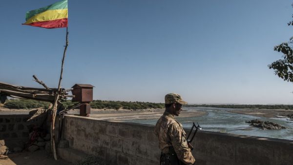 A member of the Amhara Special Forces watches on at the border crossing with Eritrea where an Imperial Ethiopian flag waves, in Humera, Ethiopia, on November 22, 2020. EDUARDO SOTERAS / AFP