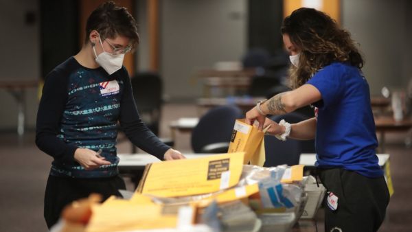 Election officials count absentee ballots on November 04, 2020 in Milwaukee, Wisconsin. Wisconsin requires election officials to wait to begin counting absentee ballots until after polls open on election day. The Milwaukee count was finished about 3AM. Scott Olson/Getty Images/AFP