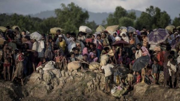 This file photo taken on October 10, 2017 shows Rohingya refugees fleeing from Myanmar arrive at the Naf river in Whaikyang, Bangladesh border.//AFP