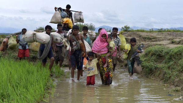 Members of Myanmar's Muslim Rohingya minority walk through a broken road at Kanjir para, at Teknaf in Cox's Bazer, Bangladesh. (Shutterstock/ File Photo)