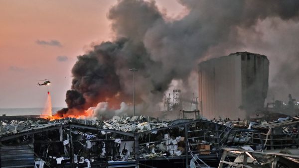A helicopter puts out a fire at the scene of an explosion at the port of Lebanon's capital Beirut, Aug. 4, 2020. AFP