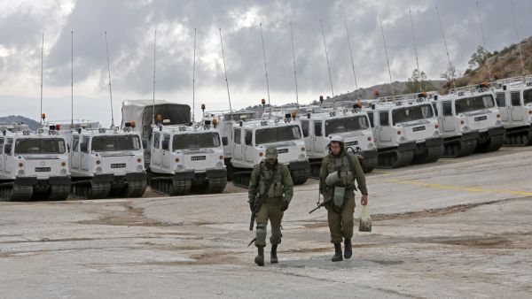 Israeli soldiers walk in the Mount Hermon military base, a strategic and fortified outpost at the crossroads between Israel, Lebanon and Syria, in the Israeli-annexed Golan Heights, on November 30, 2020. JALAA MAREY / AFP
