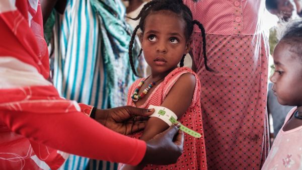 A four-year-old Ethiopian girl who fled the Tigray conflict as a refugee is measured at a malnutrition center at Village Eight transit centre near the Ethiopian border in Gedaref, eastern Sudan, on December 2, 2020. Yasuyoshi CHIBA / AFP