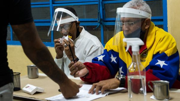 Venezuelans voted Sunday in legislative elections set to tighten President Nicolas Maduro's grip on power and further weaken his US-backed opposition rival Juan Guaido, who is leading a boycott of the polls he calls a fraud. Cristian Hernandez / AFP