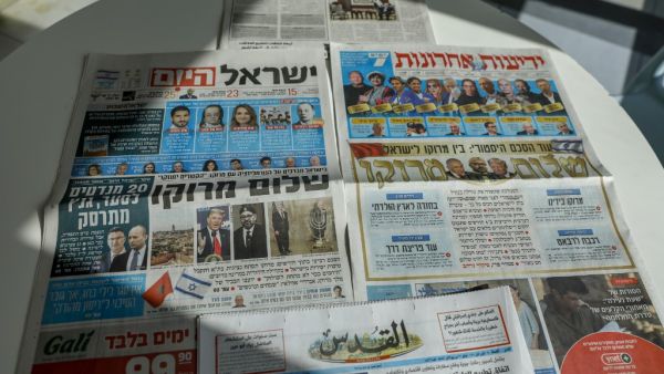 This picture taken on December 11, 2020 in Jerusalem shows Israeli and Palestinian newspapers front page titles about the announcement that Israel is to establish diplomatic relations with Morocco. Outgoing President Donald Trump's double announcement of a normalisation of ties between Morocco and Israel and US recognition of Moroccan sovereignty over Western Sahara has prompted mixed reactions. In a statement by the royal palace, Morocco's King Mohammed VI confirmed on December 10 that his country would "r