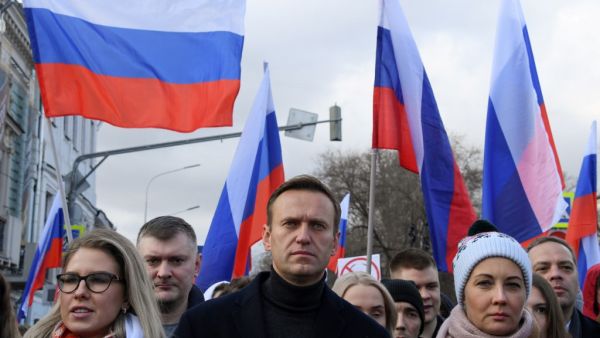 In this file photo taken on February 29, 2020 Russian opposition leader Alexei Navalny, his wife Yulia, opposition politician Lyubov Sobol and other demonstrators take part in a march in memory of murdered Kremlin critic Boris Nemtsov in downtown Moscow on February 29, 2020. Navalny, 44, was hospitalised in the Russian city of Omsk after he collapsed on a flight from Siberia to Moscow in August 2020 and then transported by medical aircraft to Berlin. Chemical weapons experts from Russia's Federal Security Service (FSB) tailed Kremlin critic Alexei Navalny for several years, including on the day of his poisoning, according to a joint media investigation. The investigative website Bellingcat -- together with the US network CNN, Russia's The Insider and Germany's Der Spiegel -- published on December 14, 2020 a joint report revealing the names and photos of men who they say specialise in nerve agents and toxins, such as Novichok. Kirill KUDRYAVTSEV / AFP  In this file photo taken on February 29, 2020 Russian opposition leader Alexei Navalny, his wife Yulia, opposition politician Lyubov Sobol and other demonstrators take part in a march in memory of murdered Kremlin critic Boris Nemtsov in downtown Moscow on February 29, 2020. Navalny, 44, was hospitalised in the Russian city of Omsk after he collapsed on a flight from Siberia to Moscow in August 2020 and then transported by medical aircraft to Berlin. Chemical weapons experts from Russia's Federal Security