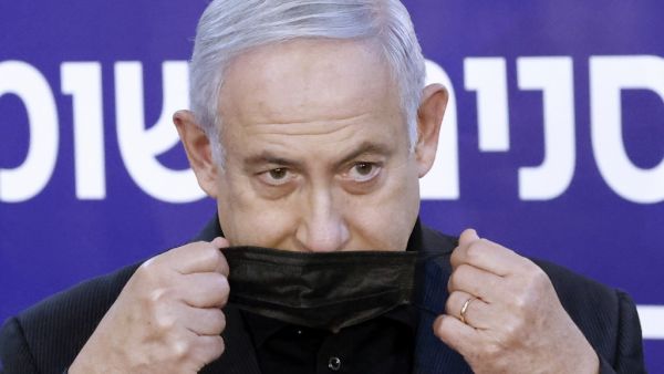 Israeli Prime Minister Benjamin Netanyahu wears a protective mask after receiving a coronavirus vaccine at the Sheba Medical Center, the country's largest hospital, in Ramat Gan near the coastal city of Tel Aviv, on December 19, 2020. Netanyahu, 71, and Israel's health minister were injected with the Pfizer-BioNTech vaccine live on TV at Sheba Medical Center. Each recipient must receive a booster shot in three weeks for optimal protection from the novel coronavirus. JACK GUEZ / AFP