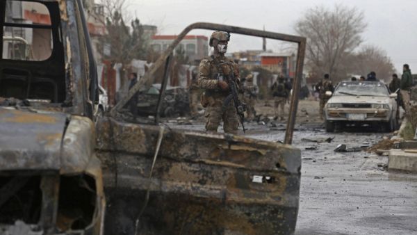 A member of Afghan security force stands guard at the site of an attack in Kabul on December 20, 2020. A car bomb targeting an Afghan lawmaker killed nine people and wounded more than a dozen in Kabul on December 20, officials said, the latest attack to rock the capital. Zakeria HASHIMI / AFP