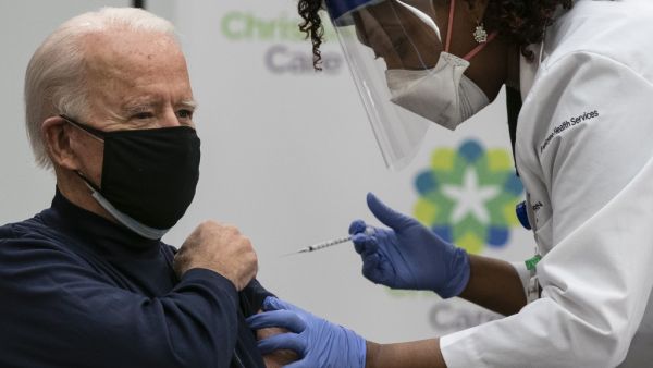 US President-elect Joe Biden receives a Covid-19 vaccination from Tabe Mase, Nurse Practitioner and Head of Employee Health Services, at the Christiana Care campus in Newark, Delaware on December 21, 2020.   ALEX EDELMAN / AFP