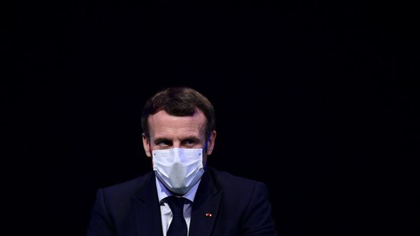 In this file photo taken on December 14, 2020 French President Emmanuel Macron attends a ceremony marking the 60th anniversary of the creation of the Organisation for Economic Co-operation and Development (OECD), at its headquarters in Paris. French President Emmanuel Macron, who had tested positive for Covid-19 on December 17, "is no longer presenting any symptoms" and his isolation of seven days can therefore stop, the Elysee Palace said in a statement on December 24, 2020. MARTIN BUREAU / POOL / AFP