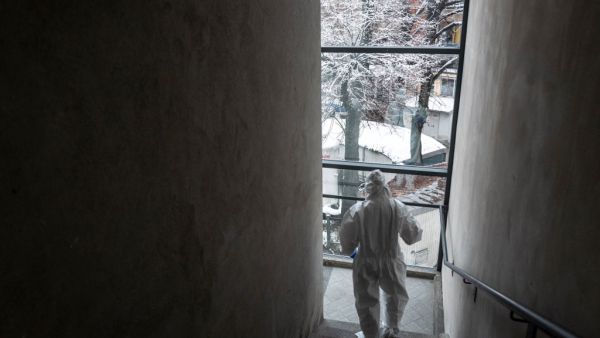 Doctor Marta Castagnotto, part of the USCA special care unit of ASL of Alba, walks down stairs at the Usca Clinic in San Lazzaro Hospital in Alba, on December 28, 2020, amid the crisis linked with the Covid-19 pandemic caused by the novel coronavirus. Marco Bertorello / AFP